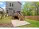 Backyard view showcasing a wooden deck with stairs leading to a concrete patio at 419 E East Hinton St, Clayton, NC 27520