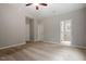 A spacious bedroom with neutral walls and plush carpeting and a ceiling fan, with natural light streaming through the window at 419 E East Hinton St, Clayton, NC 27520