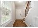 Bright entryway featuring hardwood floors, staircase with a dark railing and natural light at 419 E East Hinton St, Clayton, NC 27520