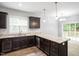 Kitchen featuring granite countertops, ample cabinet space, stainless steel appliances, and modern fixtures at 419 E East Hinton St, Clayton, NC 27520