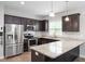 Open kitchen with granite countertops, stainless steel appliances, and a breakfast bar at 419 E East Hinton St, Clayton, NC 27520