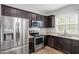 Spacious kitchen showcasing stainless steel appliances and dark wood cabinets at 419 E East Hinton St, Clayton, NC 27520