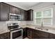 Kitchen featuring stainless steel appliances, granite countertops, and stylish backsplash at 419 E East Hinton St, Clayton, NC 27520