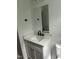 Modern bathroom with quartz countertop, white cabinets, black faucet, and a frameless mirror at 427 Lakeland St, Durham, NC 27701