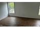 Well-lit bedroom featuring hardwood flooring and natural light from the window at 427 Lakeland St, Durham, NC 27701