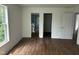 Bedroom with hardwood flooring showcasing an en suite bathroom and closet at 427 Lakeland St, Durham, NC 27701