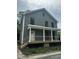 Charming two-story home featuring gray siding, a covered porch, and new construction at 427 Lakeland St, Durham, NC 27701