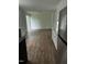 Open-concept living room with hardwood floors, stainless refrigerator, and sliding glass doors at 427 Lakeland St, Durham, NC 27701