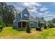 A beautiful backyard, featuring a manicured lawn, trees, and screened-in porch at 4412 Powell Grove Ct, Raleigh, NC 27606