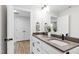 Modern bathroom featuring double sinks, a dark countertop, and contemporary fixtures at 4412 Powell Grove Ct, Raleigh, NC 27606