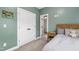 Olive bedroom with double closet doors and access to an ensuite bathroom at 4412 Powell Grove Ct, Raleigh, NC 27606