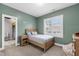 Comfortable bedroom with a bed, wooden furniture and shuttered windows at 4412 Powell Grove Ct, Raleigh, NC 27606