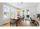 Dining area with natural light and modern features, showcasing a view to an outdoor patio and workspace at 4412 Powell Grove Ct, Raleigh, NC 27606