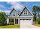Charming two-story home featuring a well-manicured lawn, a two-car garage, and distinctive gray siding at 4412 Powell Grove Ct, Raleigh, NC 27606