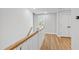 Upstairs hallway features wood floors, white walls, and access to a linen closet and several rooms at 4412 Powell Grove Ct, Raleigh, NC 27606