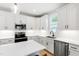 Contemporary kitchen with white cabinets, subway tile backsplash, and stainless steel appliances at 4412 Powell Grove Ct, Raleigh, NC 27606