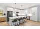Modern kitchen with white cabinetry, stainless steel appliances, a large island, and barstool seating at 4412 Powell Grove Ct, Raleigh, NC 27606