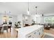 Spacious kitchen featuring a large island with seating, stainless appliances, and open floor plan to a living area at 4412 Powell Grove Ct, Raleigh, NC 27606