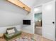 Attic playroom with a wall-mounted television and a doorway to a bedroom at 4412 Powell Grove Ct, Raleigh, NC 27606