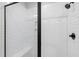 Beautiful tiled stand-up shower with black trim and rain-style showerhead features a built in bench at 4412 Powell Grove Ct, Raleigh, NC 27606