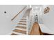 Bright entryway features wood stairs, white walls, and modern fixtures plus access to a hall bathroom at 4412 Powell Grove Ct, Raleigh, NC 27606