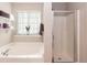 Bright bathroom with a soaking tub, glass shower and plenty of natural light at 45 Davelyn Ct, Garner, NC 27529