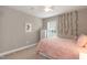 Cozy bedroom featuring a ceiling fan, and a soft pink bedspread, bathed in natural light at 45 Davelyn Ct, Garner, NC 27529