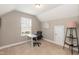 Bright bedroom with a sloped ceiling featuring a modern white desk and a comfortable chair at 45 Davelyn Ct, Garner, NC 27529