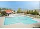 Large community pool with ample seating, a covered pavilion, and a nearby playground at 45 Davelyn Ct, Garner, NC 27529