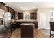 Stylish kitchen featuring dark wood cabinetry, stainless steel appliances, and a center island at 45 Davelyn Ct, Garner, NC 27529