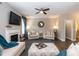 Comfortable living room featuring neutral colors, a ceiling fan, and a decorative fireplace at 45 Davelyn Ct, Garner, NC 27529