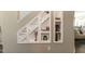 Staircase with built-in shelving featuring decorative items and books at 45 Davelyn Ct, Garner, NC 27529