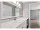 Bathroom featuring a large vanity with stylish countertop and mirror, leading to an adjacent bedroom at 5000 Avenida Del Sol Dr, Raleigh, NC 27616