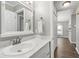 This bathroom has white cabinets, marble countertops, and a modern faucet fixture at 5000 Avenida Del Sol Dr, Raleigh, NC 27616