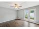 Bright bedroom with a ceiling fan and private access to the backyard through glass panel doors at 5000 Avenida Del Sol Dr, Raleigh, NC 27616
