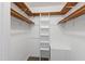 Walk-in closet with wooden shelving and a ladder for easy access to storage, maximizing organization at 5000 Avenida Del Sol Dr, Raleigh, NC 27616