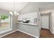 Dining area with an open concept to the kitchen and a view of the entryway, creating a spacious feel at 5000 Avenida Del Sol Dr, Raleigh, NC 27616