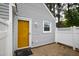 Charming home exterior showcases a bright yellow front door and gray siding at 5000 Avenida Del Sol Dr, Raleigh, NC 27616