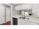 Stylish kitchen featuring a stainless steel dishwasher and a view to the dining area and living room at 5000 Avenida Del Sol Dr, Raleigh, NC 27616