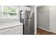 Kitchen with stainless steel refrigerator, window, and white cabinets for a clean, functional design at 5000 Avenida Del Sol Dr, Raleigh, NC 27616