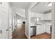 Well-lit kitchen area with stainless steel appliances flowing into an open-concept living space at 5000 Avenida Del Sol Dr, Raleigh, NC 27616