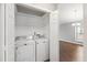 Convenient laundry closet with a washing machine and dryer adjacent to the living space at 5000 Avenida Del Sol Dr, Raleigh, NC 27616