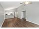 Open-concept living area with modern flooring, ceiling fan, and an adjoining room with a kitchen bar at 5000 Avenida Del Sol Dr, Raleigh, NC 27616