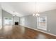 Open-concept living room with lots of light, a fireplace, ceiling fan and sliding door access to backyard at 5000 Avenida Del Sol Dr, Raleigh, NC 27616