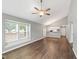 Spacious living area featuring natural light, modern flooring, and a glimpse of the kitchen bar at 5000 Avenida Del Sol Dr, Raleigh, NC 27616