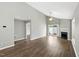 Spacious living room with fireplace, ceiling fan, and sliding door to backyard, offering plenty of natural light at 5000 Avenida Del Sol Dr, Raleigh, NC 27616