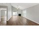 Bright living room with a fireplace, ceiling fan, and sliding door to outdoor space at 5000 Avenida Del Sol Dr, Raleigh, NC 27616