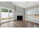Living room featuring a modern fireplace, sliding glass door, and an expansive window with blinds at 5000 Avenida Del Sol Dr, Raleigh, NC 27616