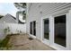 Backyard patio with sliding glass doors, white fence, and gray vinyl siding at 5000 Avenida Del Sol Dr, Raleigh, NC 27616