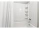 Bright white shower stall with storage shelves and chrome shower head at 5000 Avenida Del Sol Dr, Raleigh, NC 27616